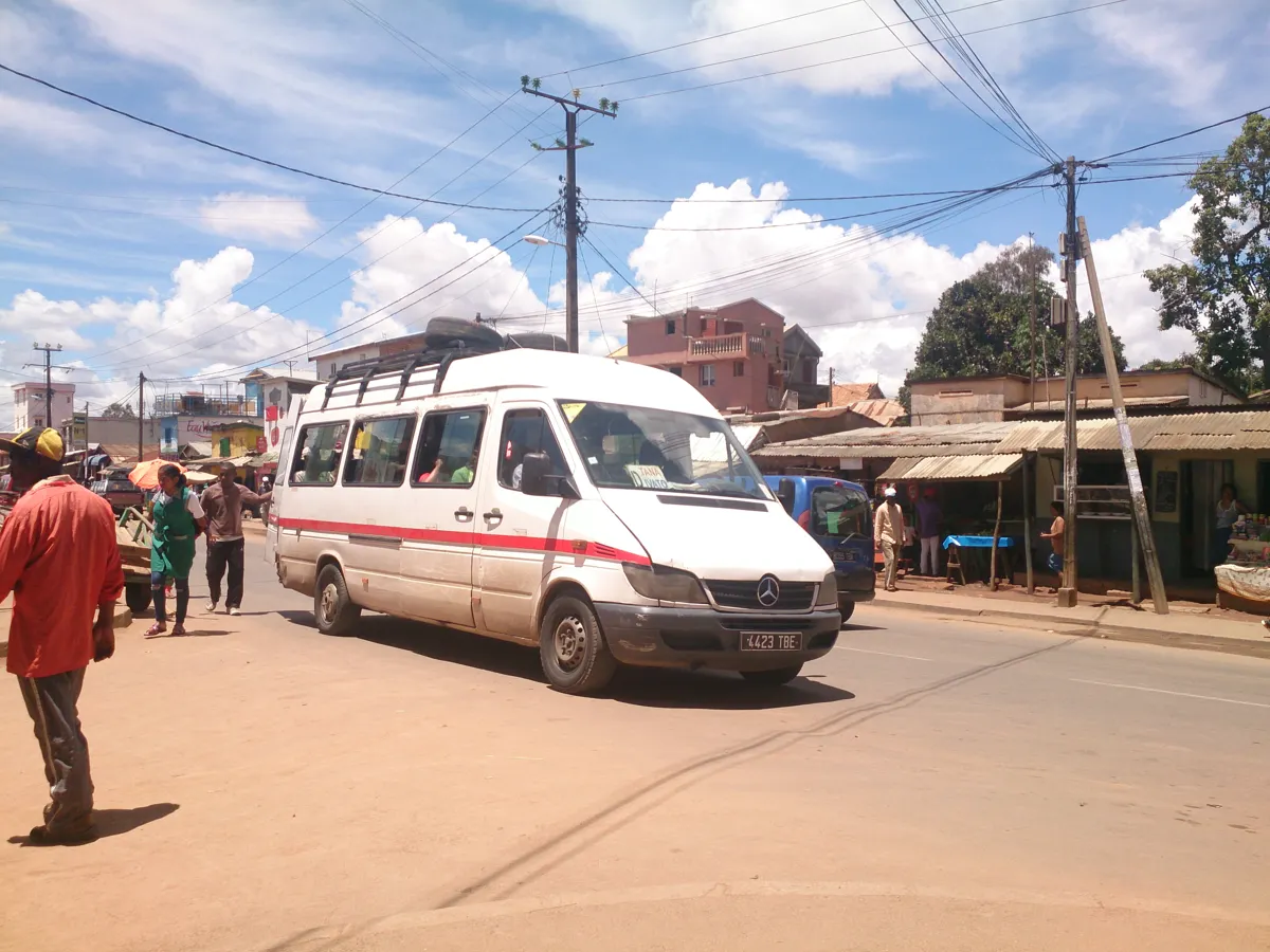 Vue extérieure d’un minibus blanc et rouge à Ivato, sans publicité sur le véhicule